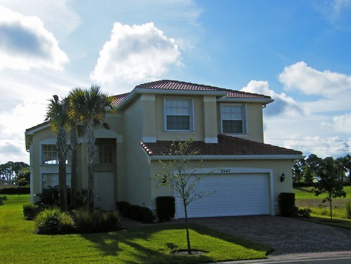 front of house, paver driveway & walk-way with accordian shutters on all windows!