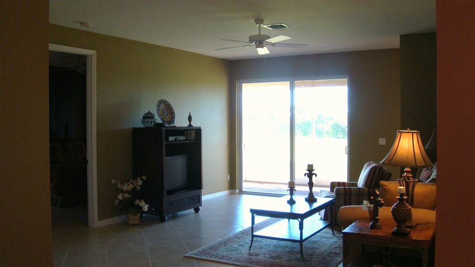 living room with slider opening to screened patio