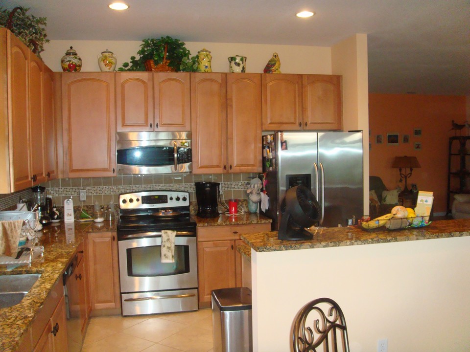 kitchen with granite counters & tile backsplash