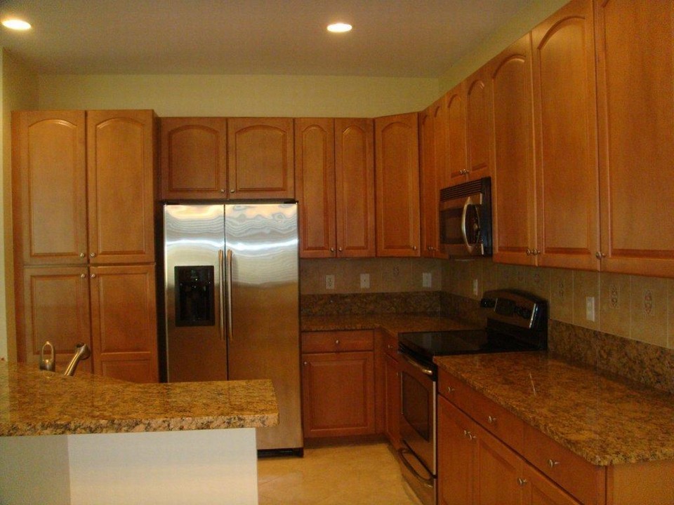 kitchen with granite counters, tile backsplash, stainless appliances