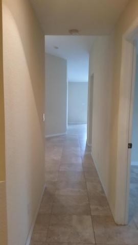 hallway leading to bedrooms, laundry room and garage