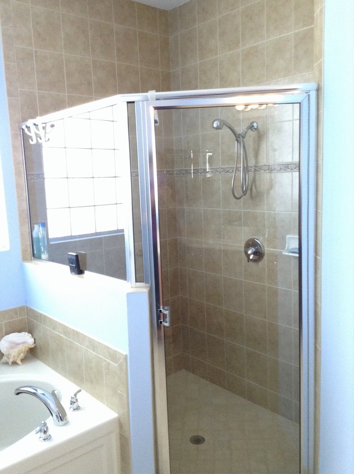 tub and shower with floor to ceiling tile
