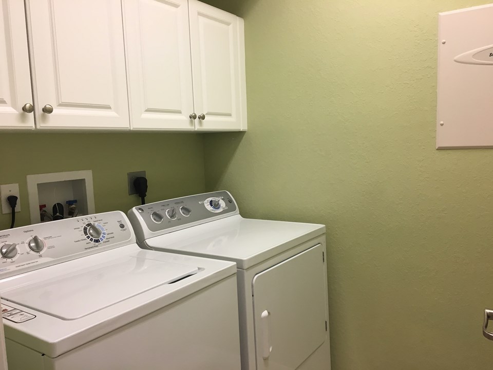 laundry room with cabinets for storage