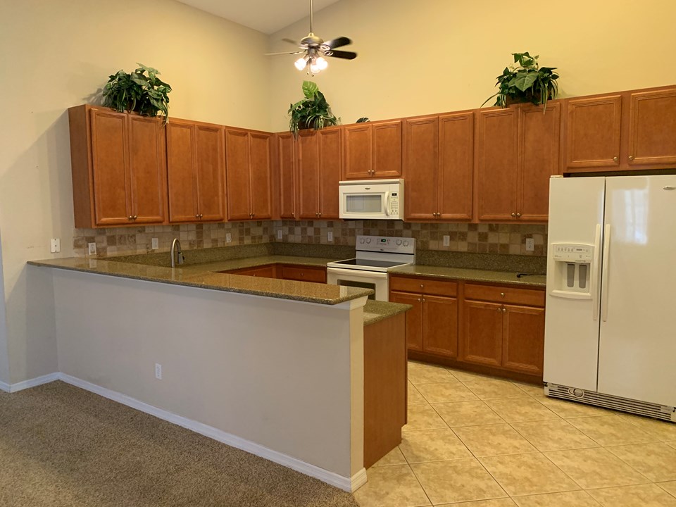 kitchen with granite and tile backsplash