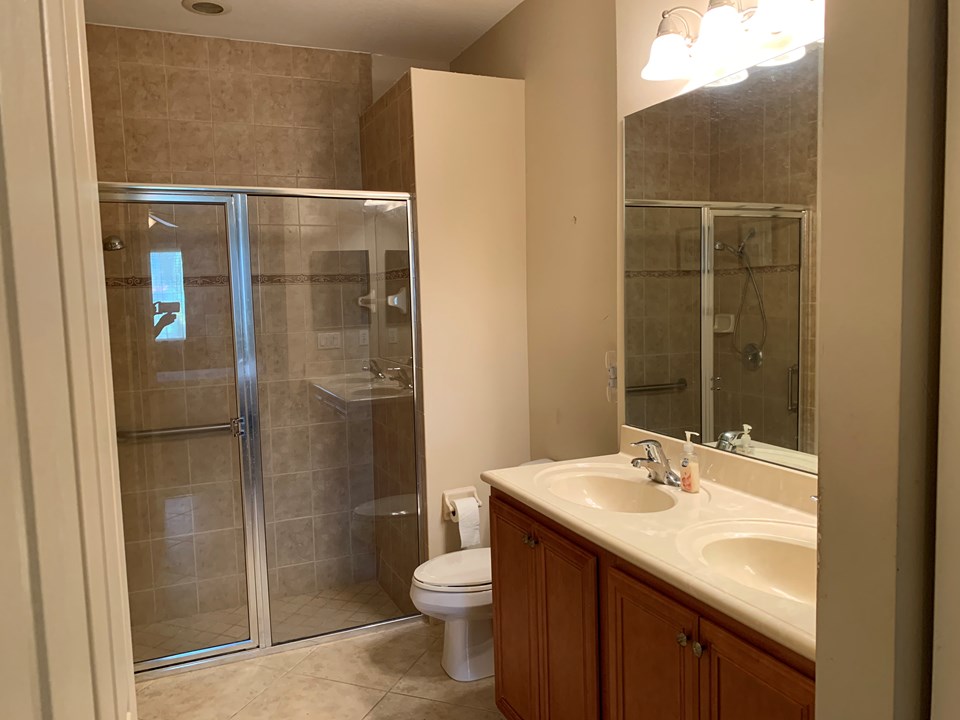 master bath with shower and dual sinks