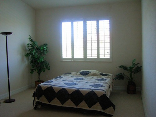master bedroom with plantation shutters