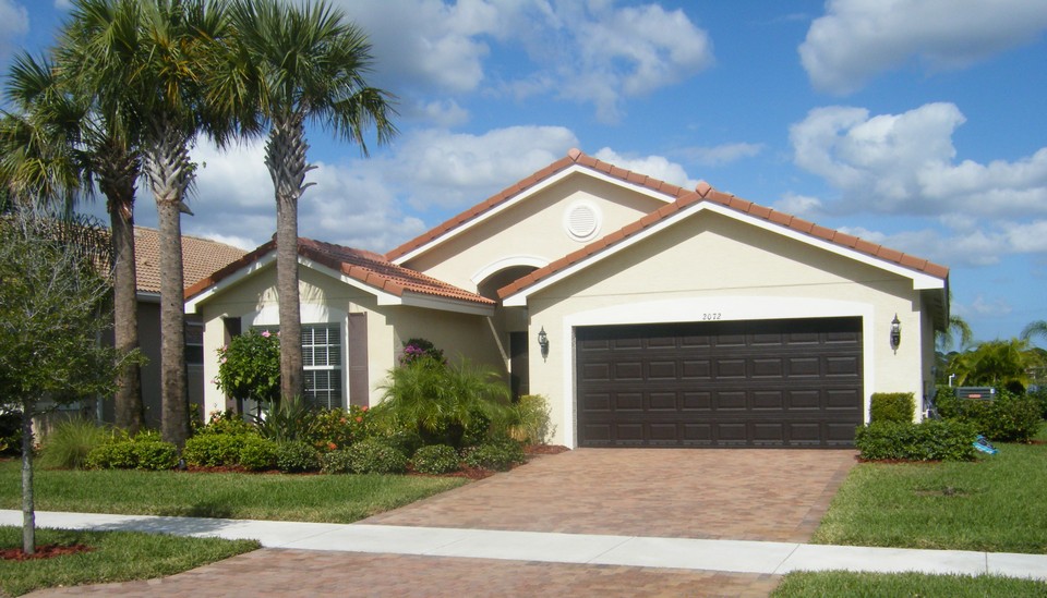 front view of home with paver driveway and walkway