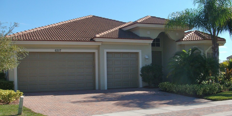 front of house, 3 car garage with paver driveway and walk-way