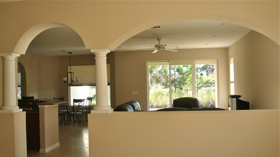 view from living room looking towards family room, kitchen and cafe
