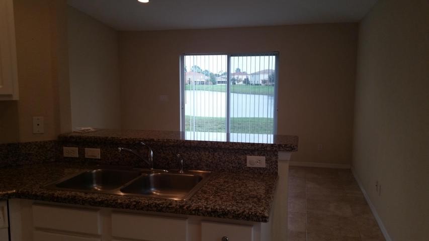 view from kitchen looking to family room & backyard