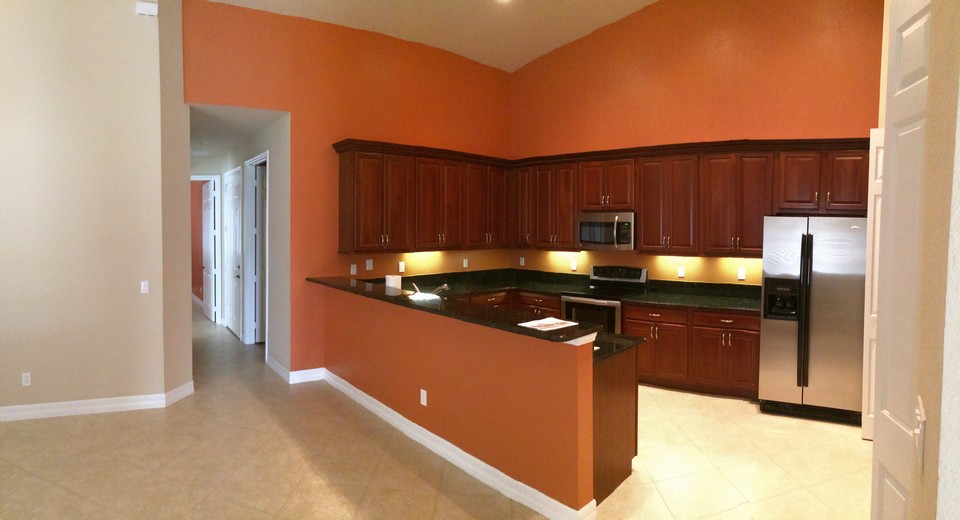 kitchen with granite counters, stainless appliances, undermount lighting