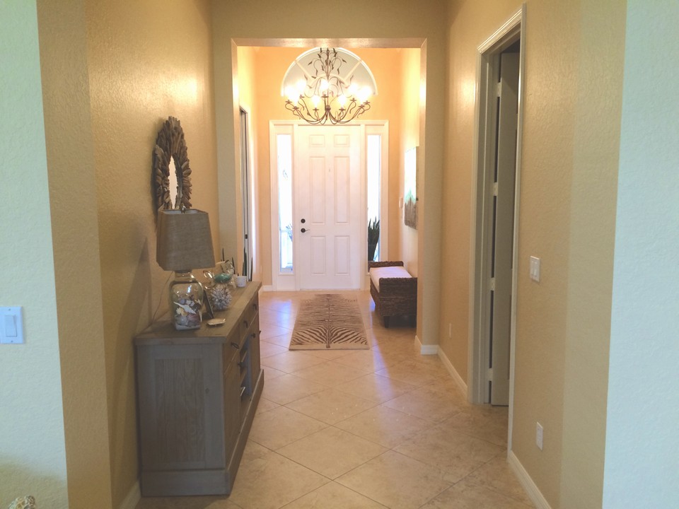 foyer entrance with crown molding 12' ceiling