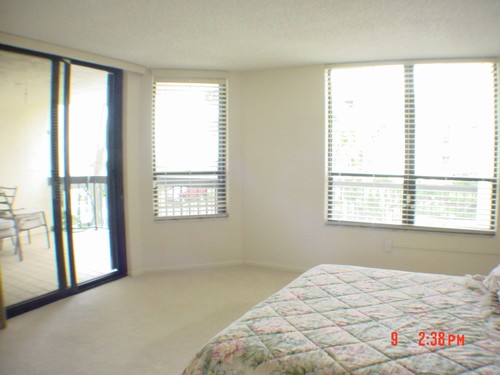 master bedroom overlooking patio, pool & ocean