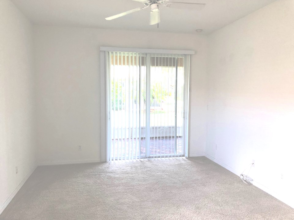master bedroom wit sliding doors opening to patio