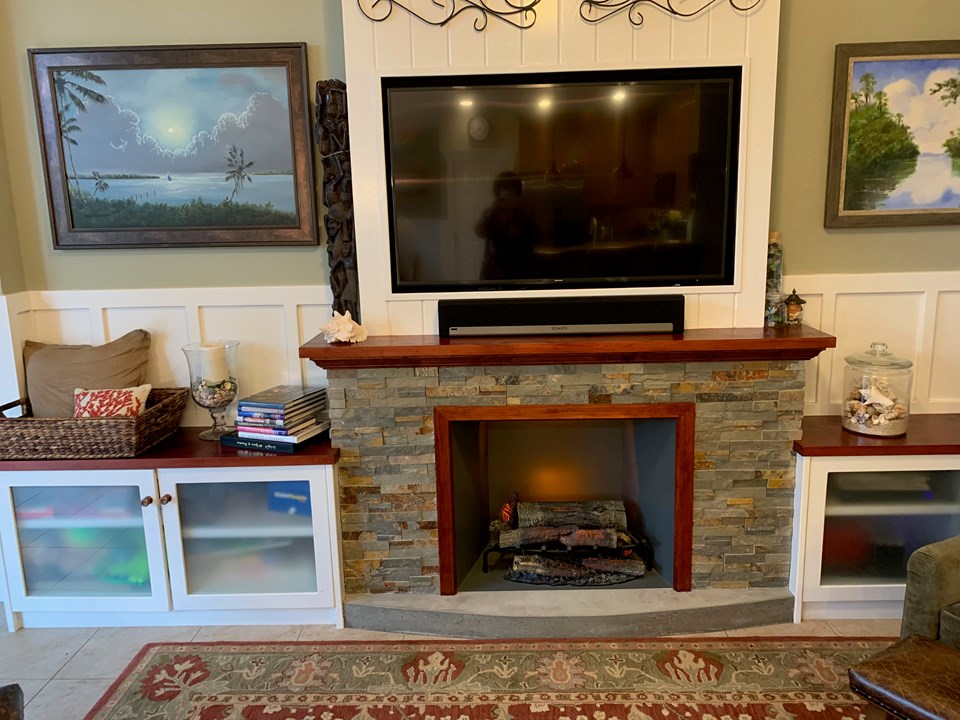 electric fireplace with stone & built-in cabinets on each side