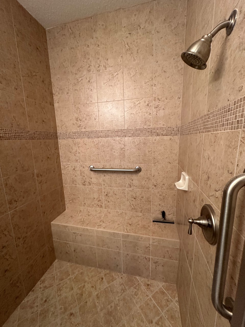master bath shower with floor to ceiling tile & bench!