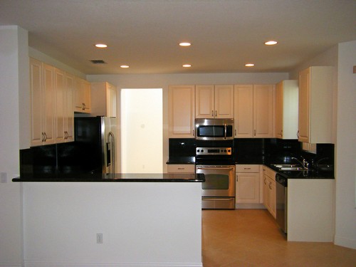 kitchen wth stunning black granite counters, stainless appliances and snack counter