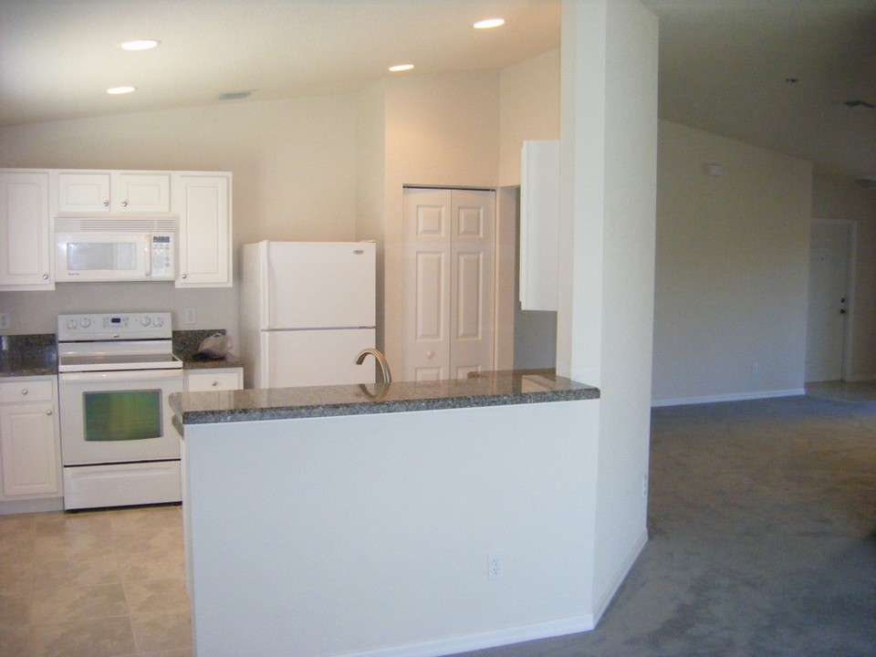 kitchen with granite counters and snack counter