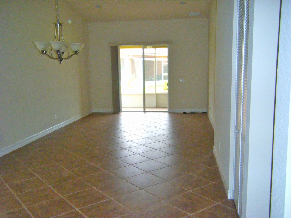 dining/living room diagonal tile looking toward screened covered patio