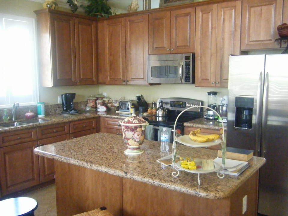 kitchen with plenty of counter & cabinet space plus an island and ss appliances