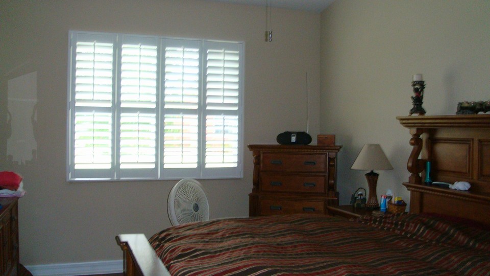 master bedroom with plantation shuters
