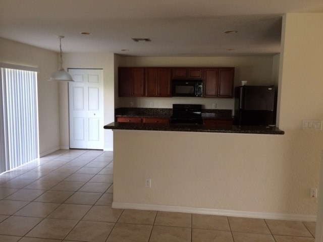 kitchen with granite counters, slider opens to patio