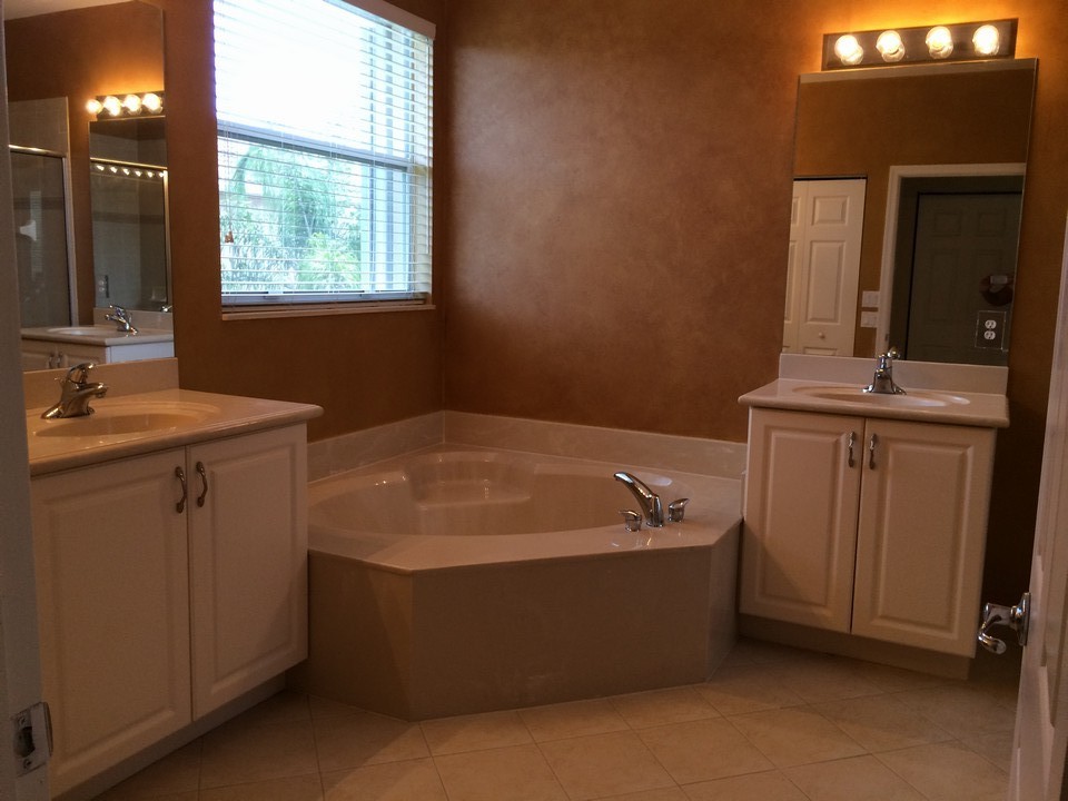 master bath with roman tub, his/her sinks and separate shower