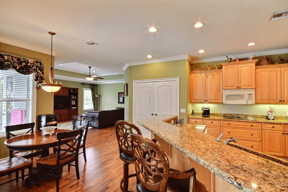 breakfast nook and kitchen with granite counters