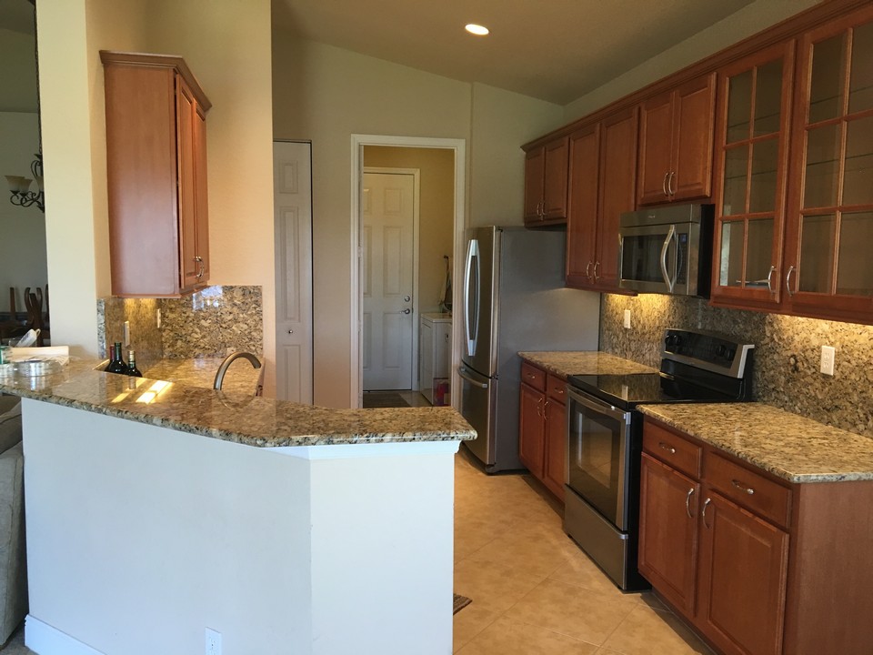 kitchen with granite counters & full backsplash, ss appliances