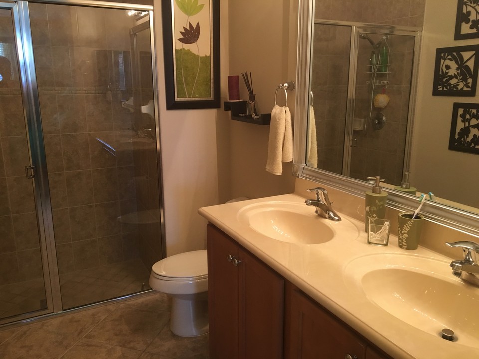 dual sinks, raised counter in master in bathroom