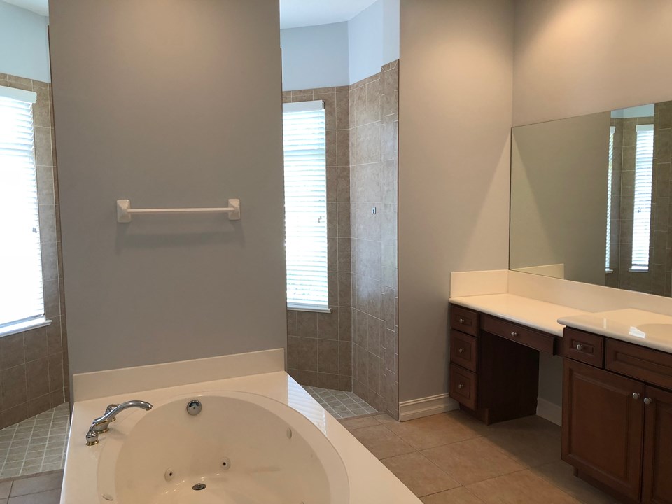 master bath with jacuzzi tub and sports shower