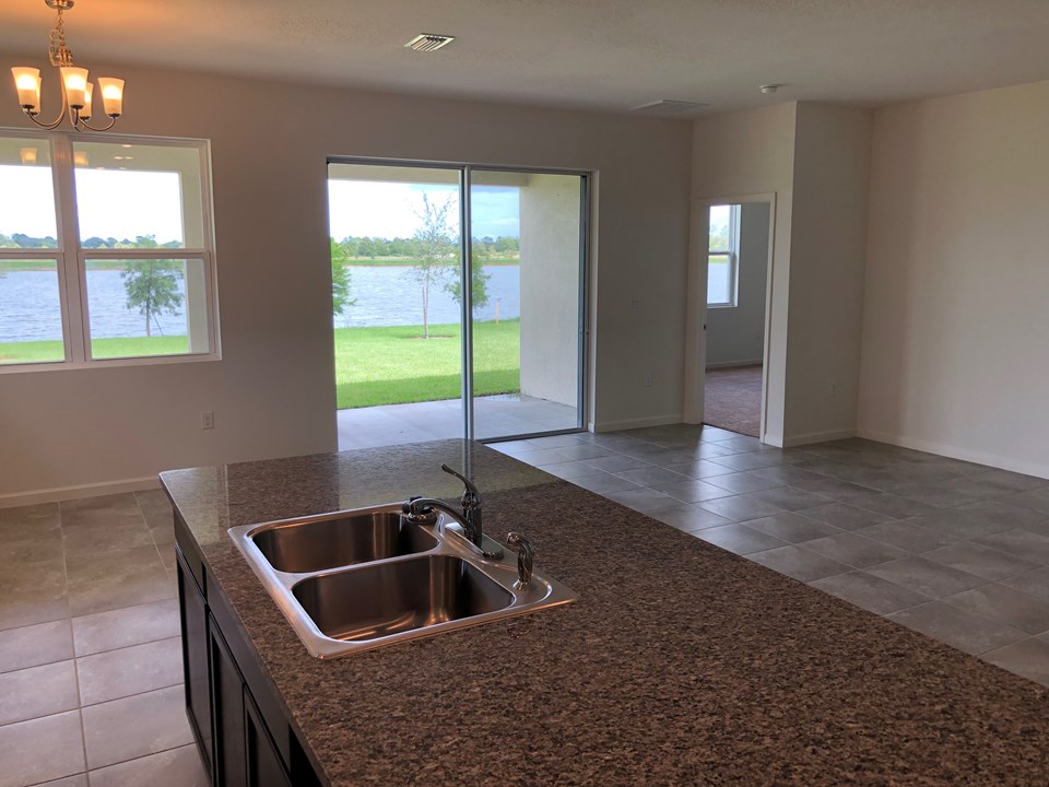 large island with granite counter, dining area