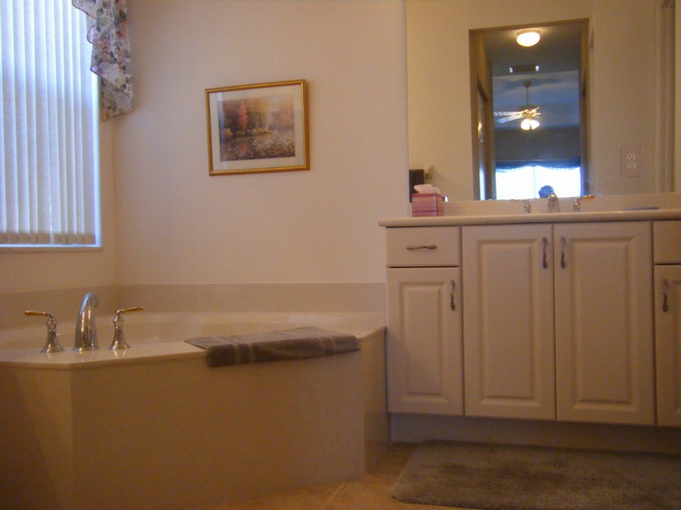 master bath, roman tub, his & her sinks with cultured marble counter tops