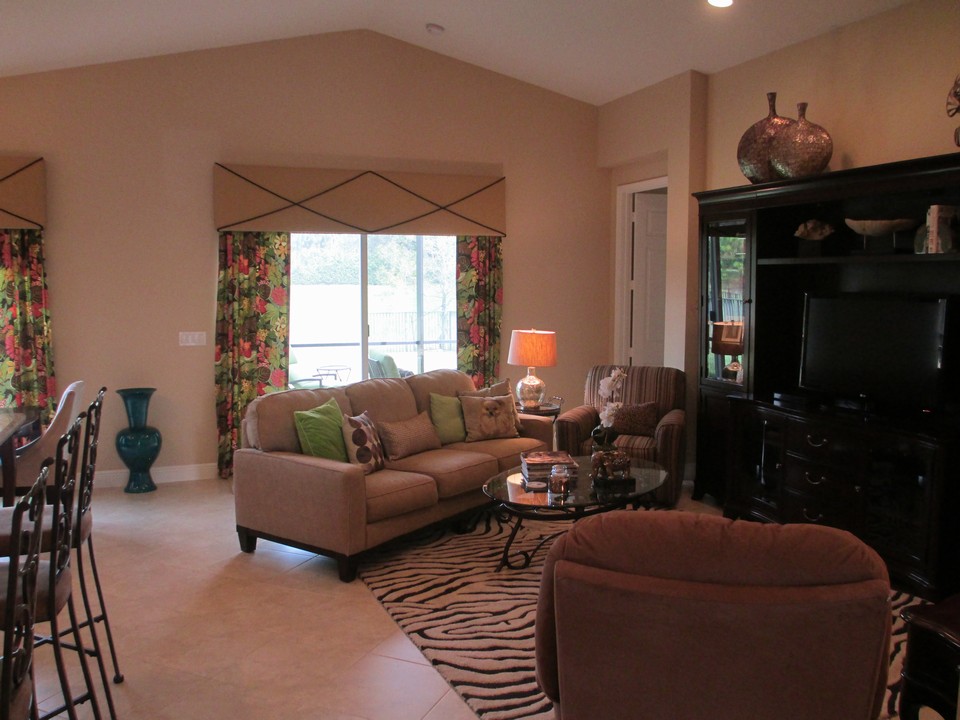 great room with sliders opening to expanded covered patio