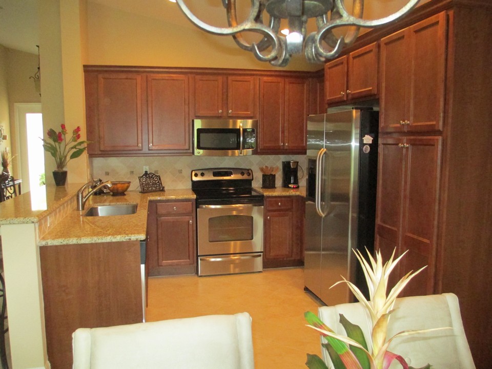 cherry cabinets, snack counter & pantry in kitchen