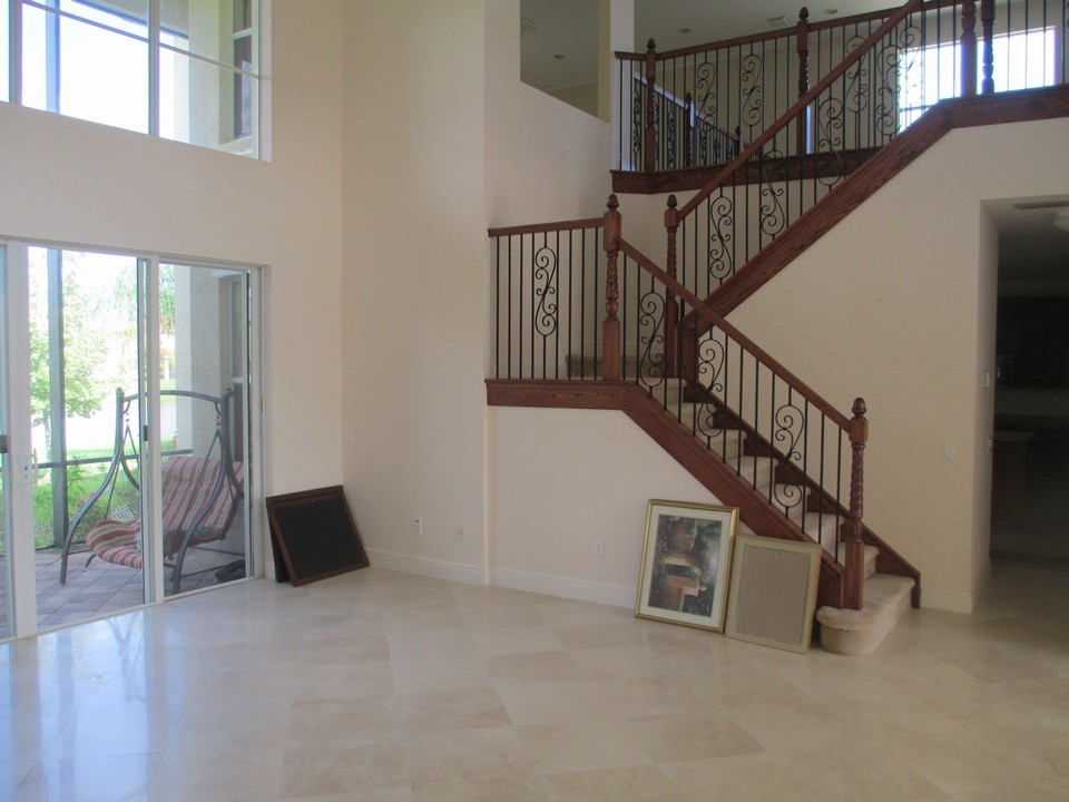 living room with wood and iron staircase