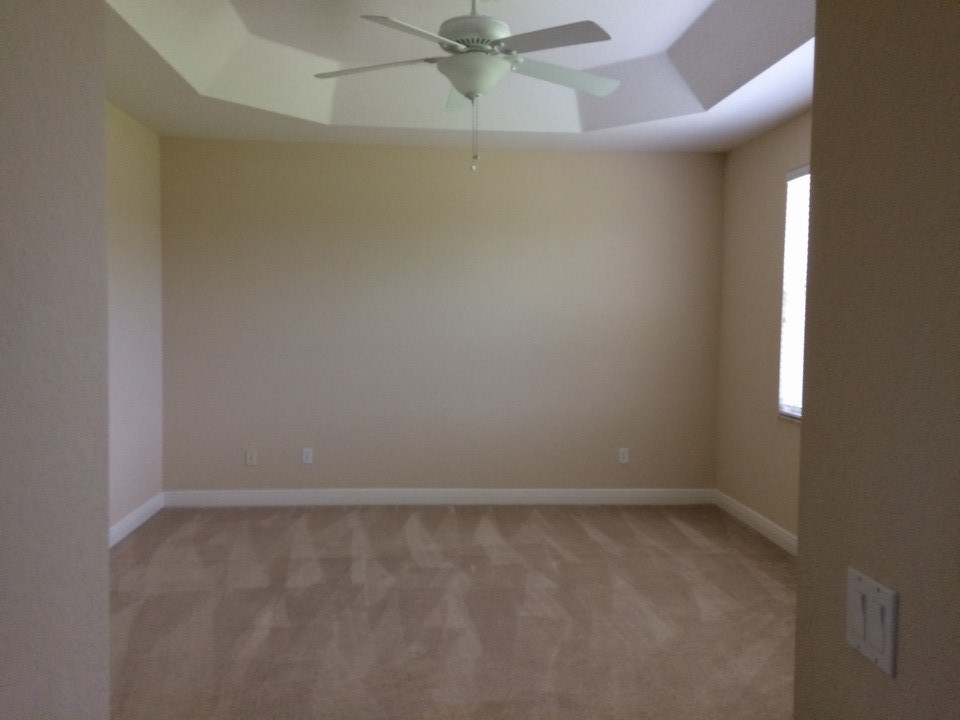 master bedroom with tray ceiling