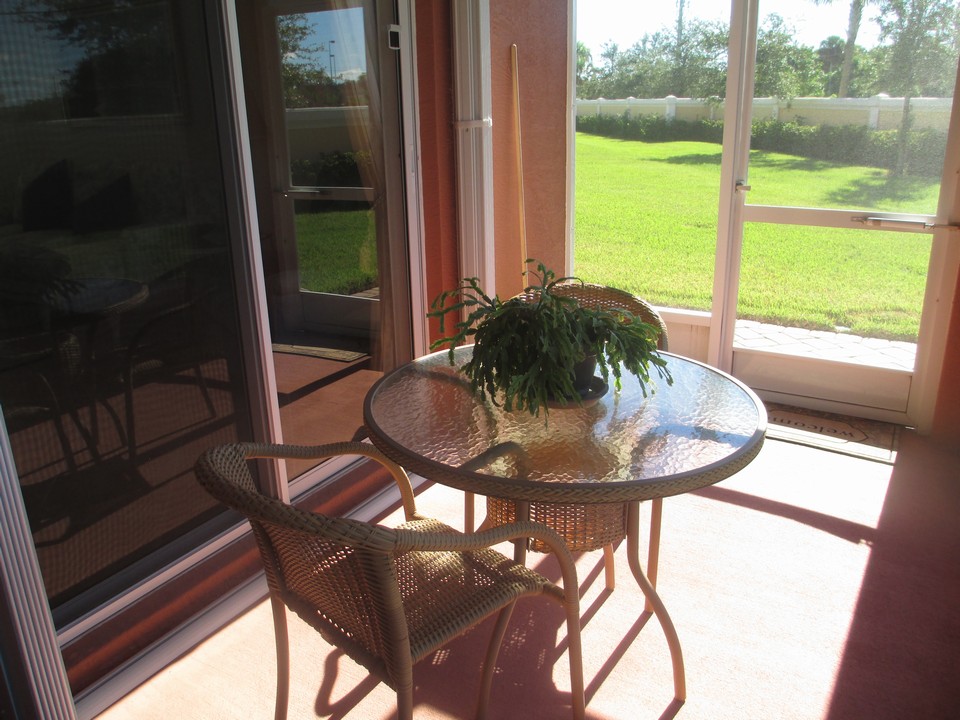 screened covered patio (note the accoridian shutters)