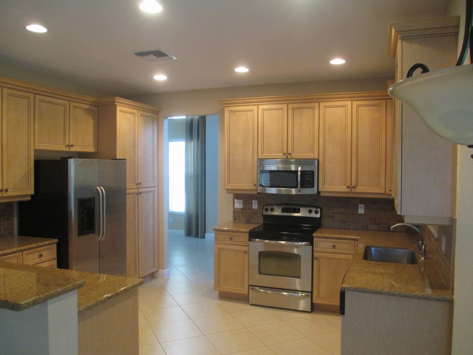 granite counters, tile backsplash, stainless appliances