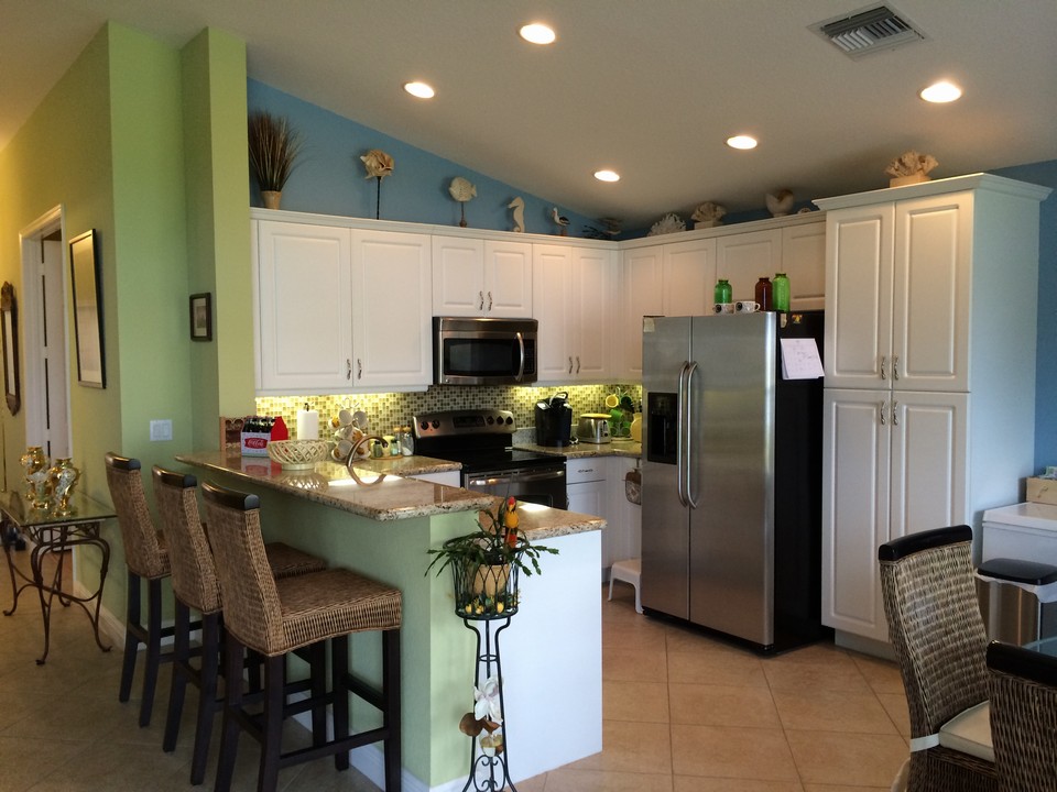 ss appliances, tile backsplash, granite counters & undermount lighting