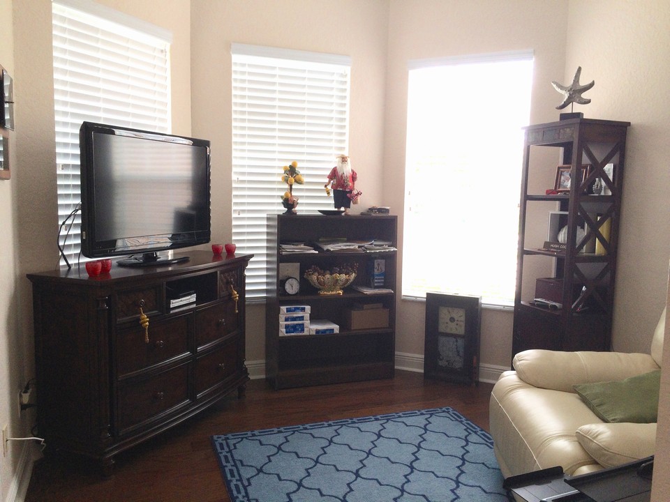 bedroom 3 with bay window and wood floors