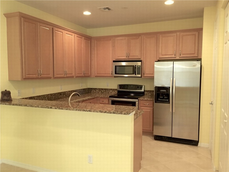 cheerful kitchen with plenty of cabinets, crown molding, pantry