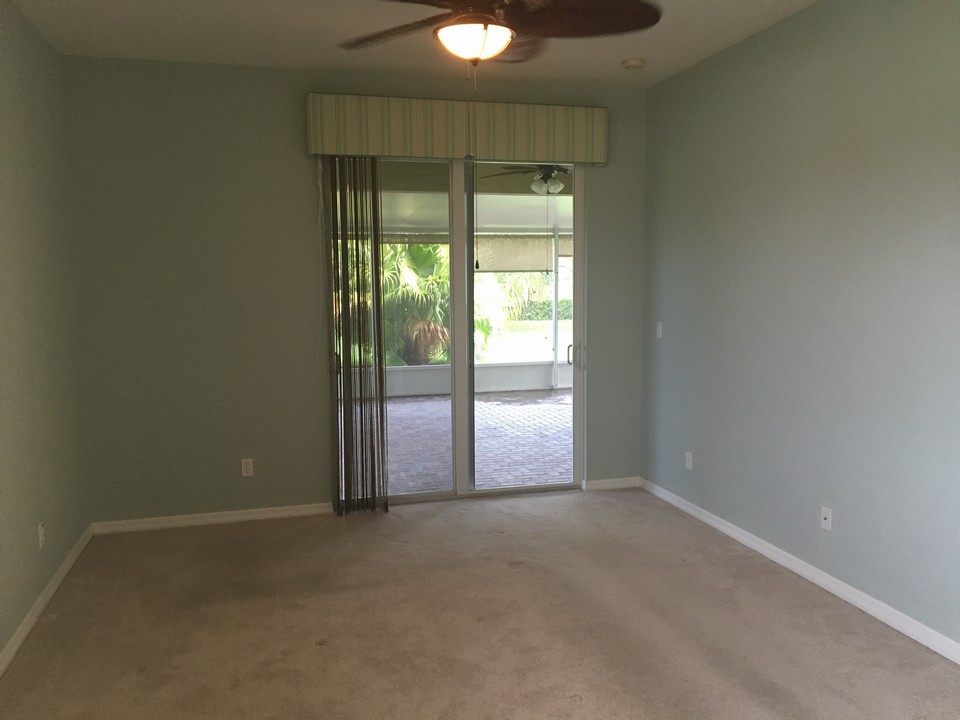 master bedroom with slider opening to patio