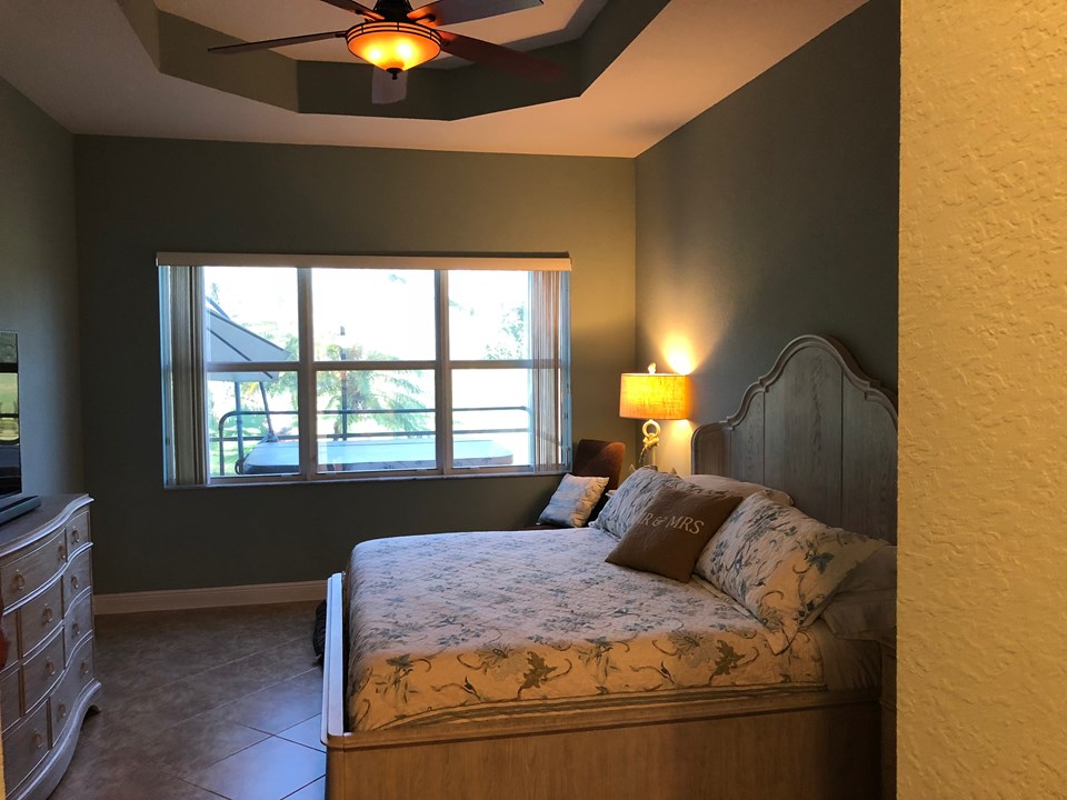 master bedroom with tray ceiling