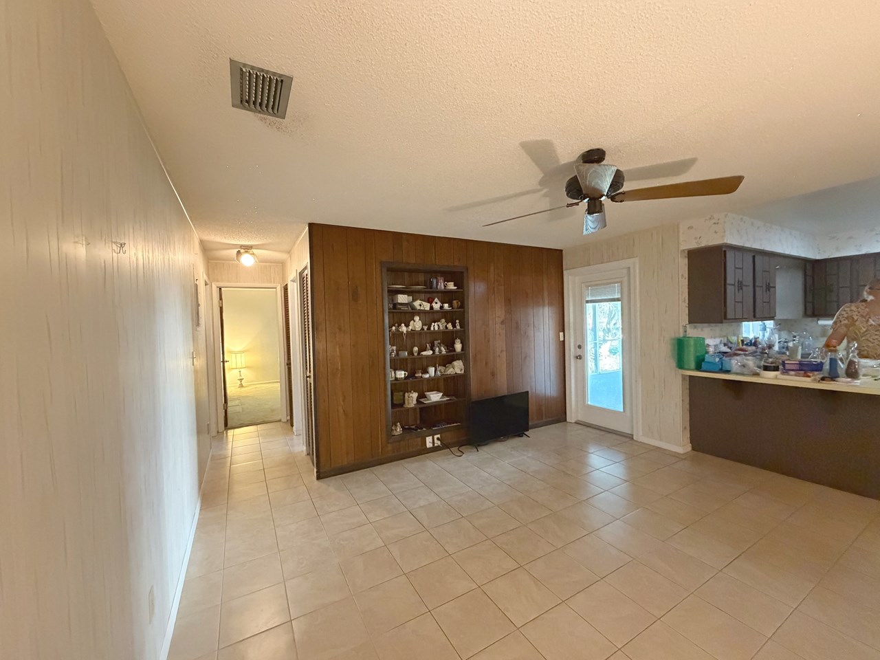 family room with door to patio and open to kitchen