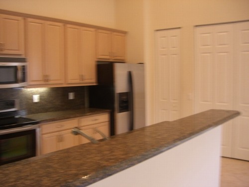 snack counter and full granite backsplash