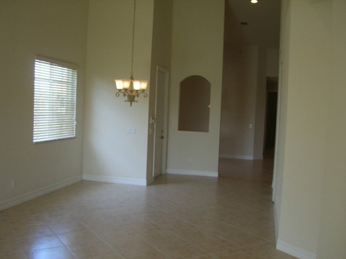 living/dining room with breakfast nook behind the curved opening